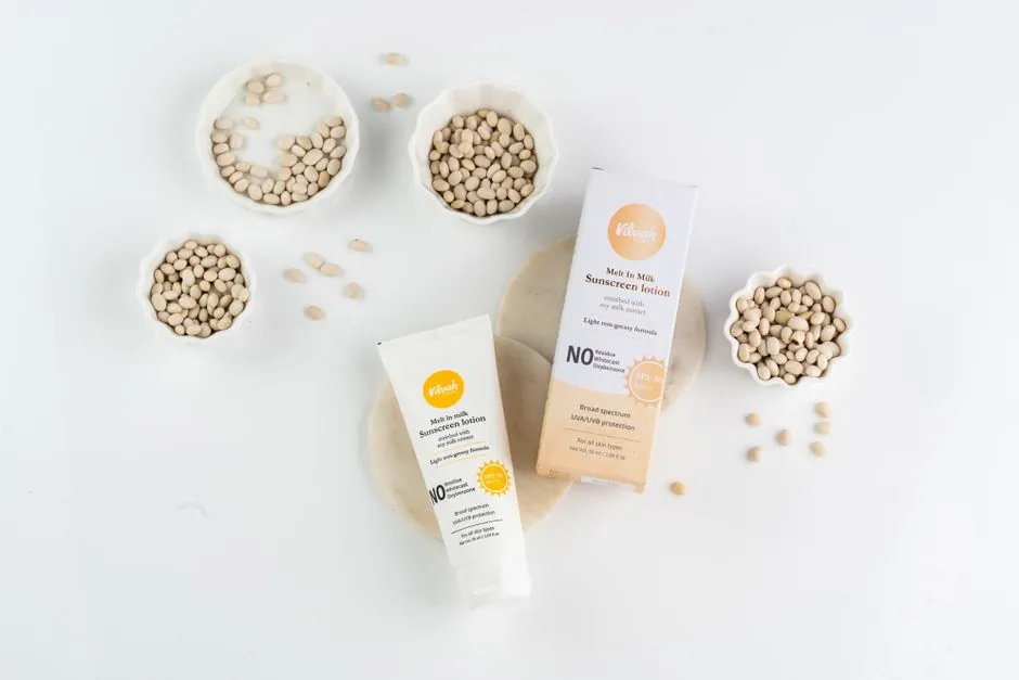 Flat lay image of sunscreen lotion with natural seeds highlighting the skincare product's organic composition.