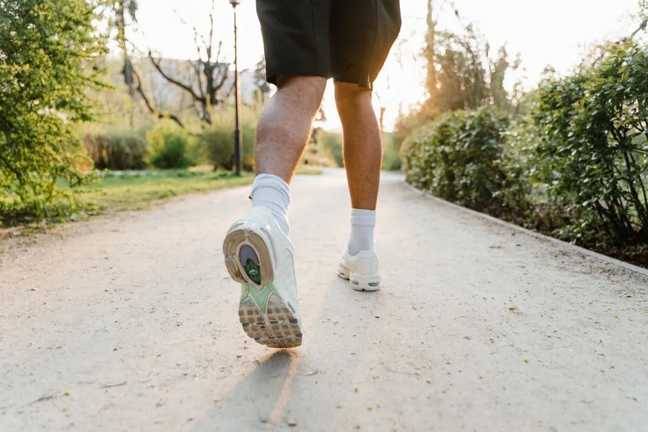 A jogger running on a park path at sunset. Emphasizes fitness and outdoor exercise.